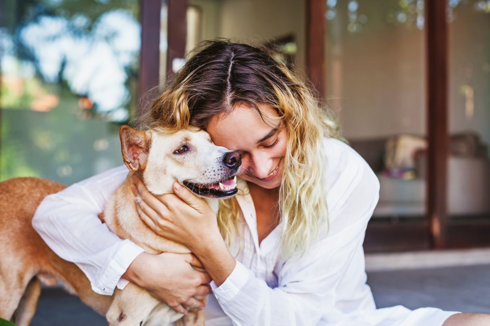Woman hugging a happy dog